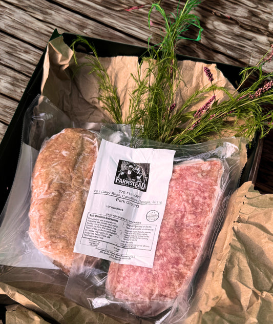 Pasture-raised ground pork from The MF Farmstead in Carrollton, Georgia, vacuum-sealed and displayed in rustic packaging with fresh greenery.