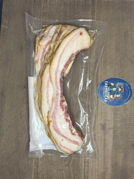 Packaged slices of berkshire bacon on a wooden surface with a visible brand for the MF'n Farmlabel.