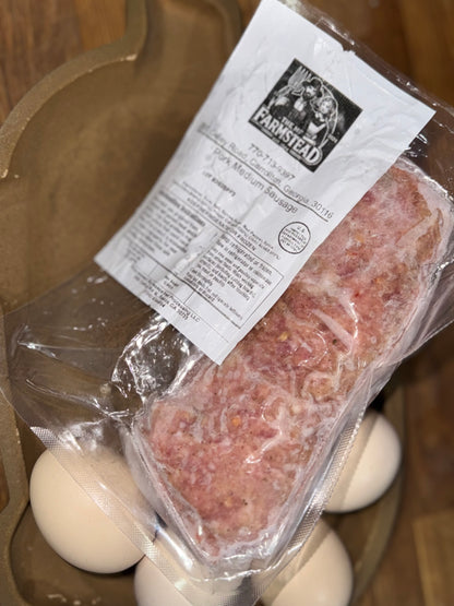 Packaged ground berkshire pork with the MF'n Farm label on a wooden surface