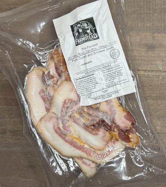Packaged berkshire Jowl bacon with the MF'n Farm label on a wooden surface