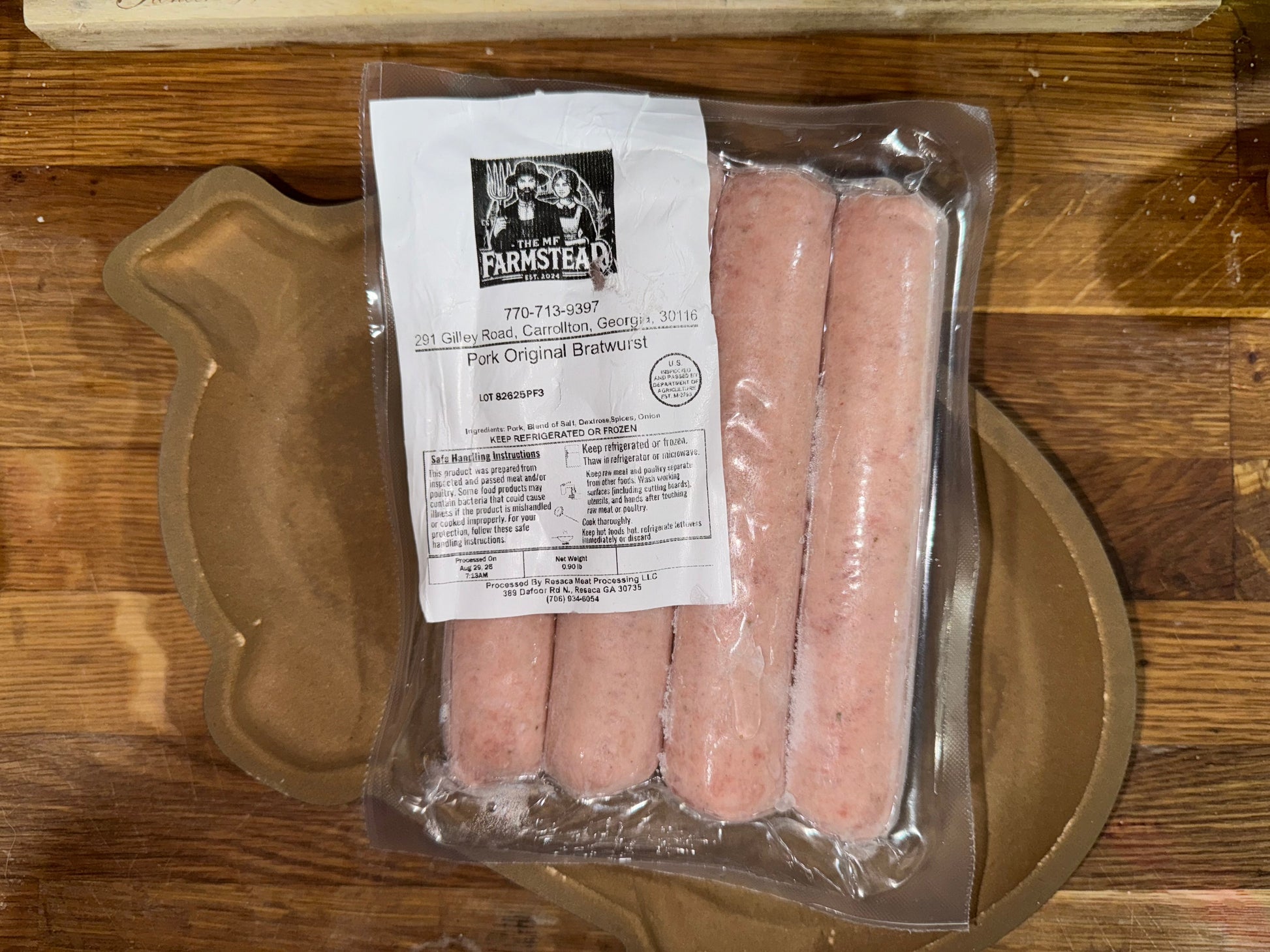 Packaged sausages with the MF'n Farm label on a wooden cutting board