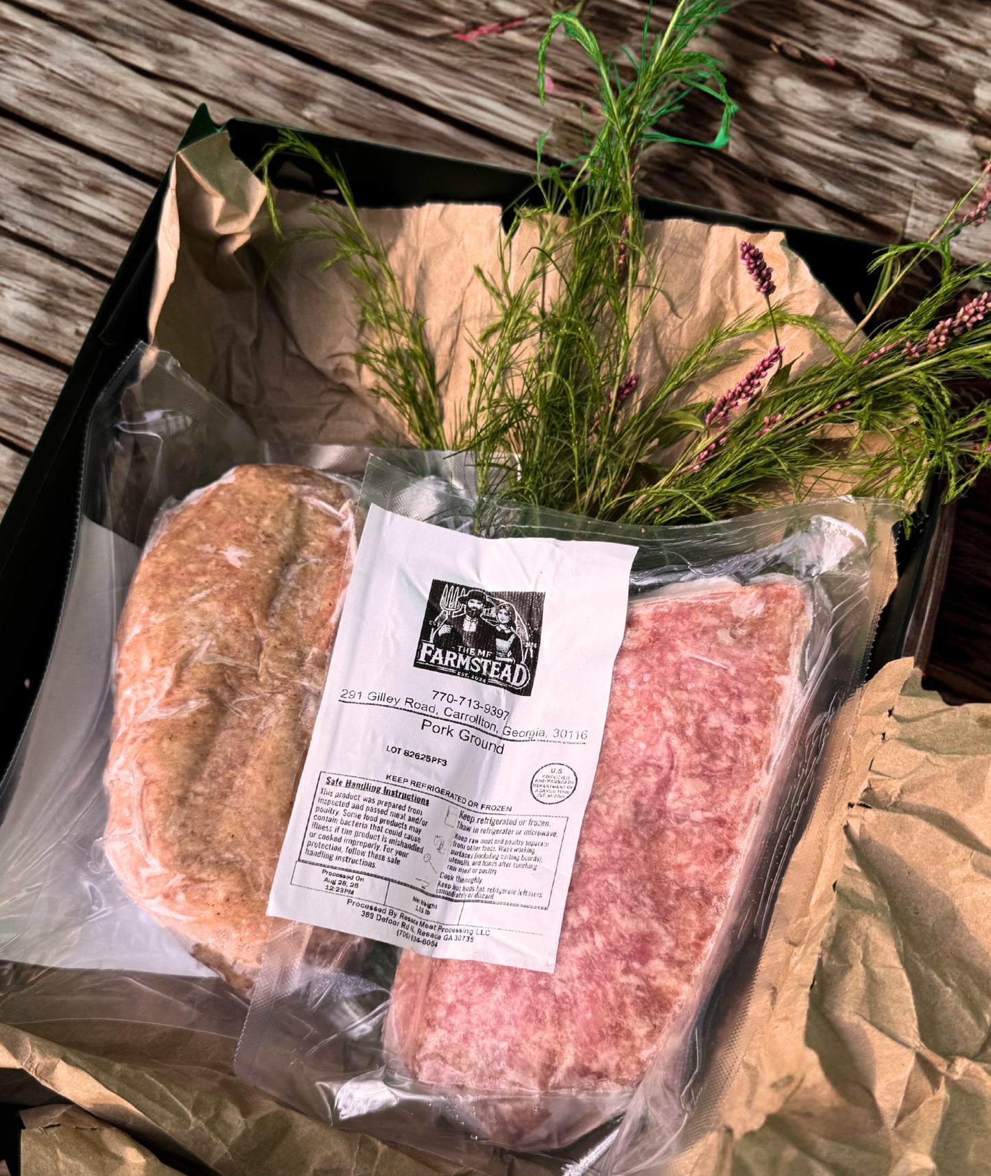 Pasture-raised ground pork from The MF Farmstead in Carrollton, Georgia, vacuum-sealed and displayed in rustic packaging with fresh greenery.